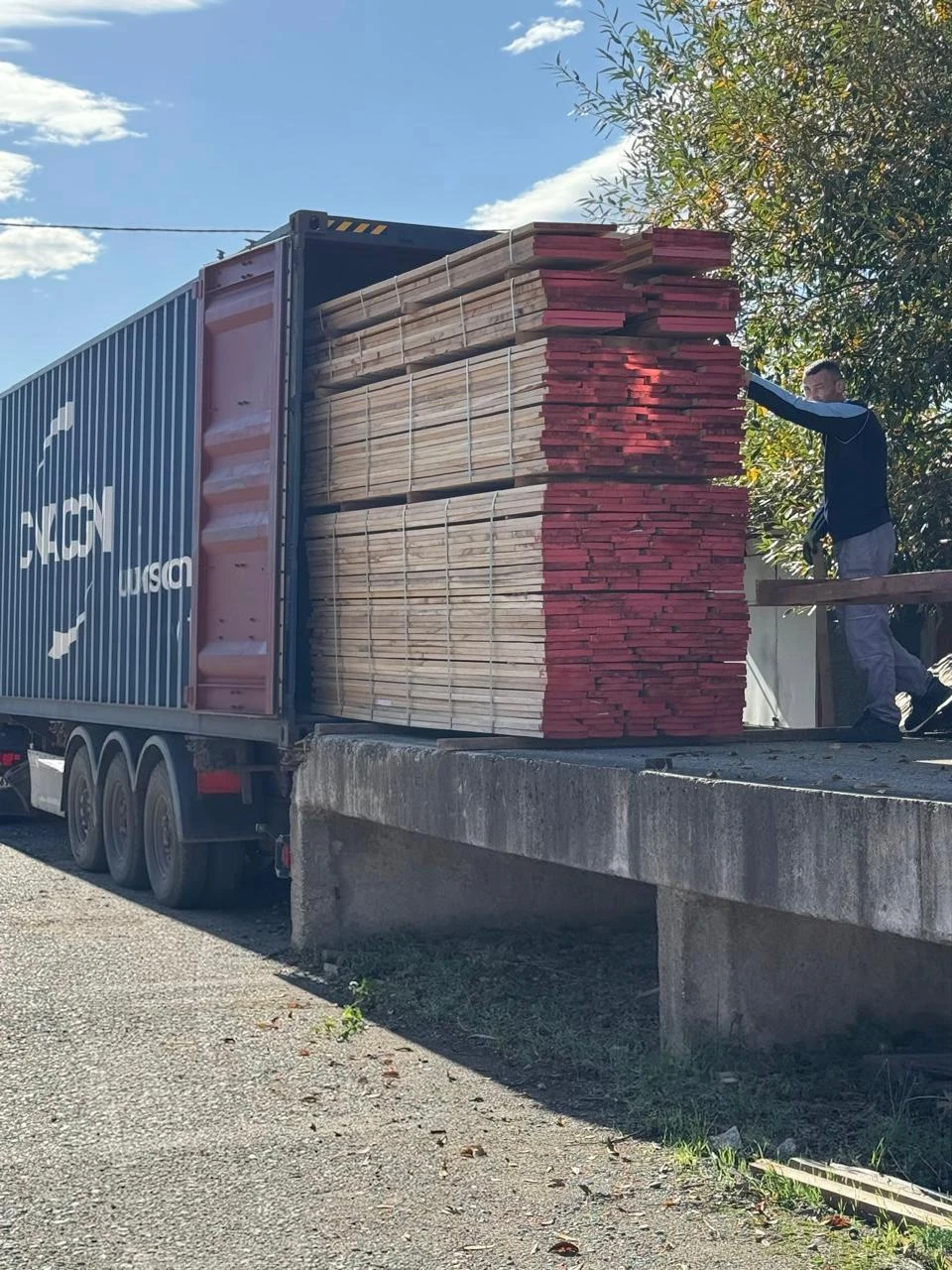 Oak lumber being loaded into a container at the mill